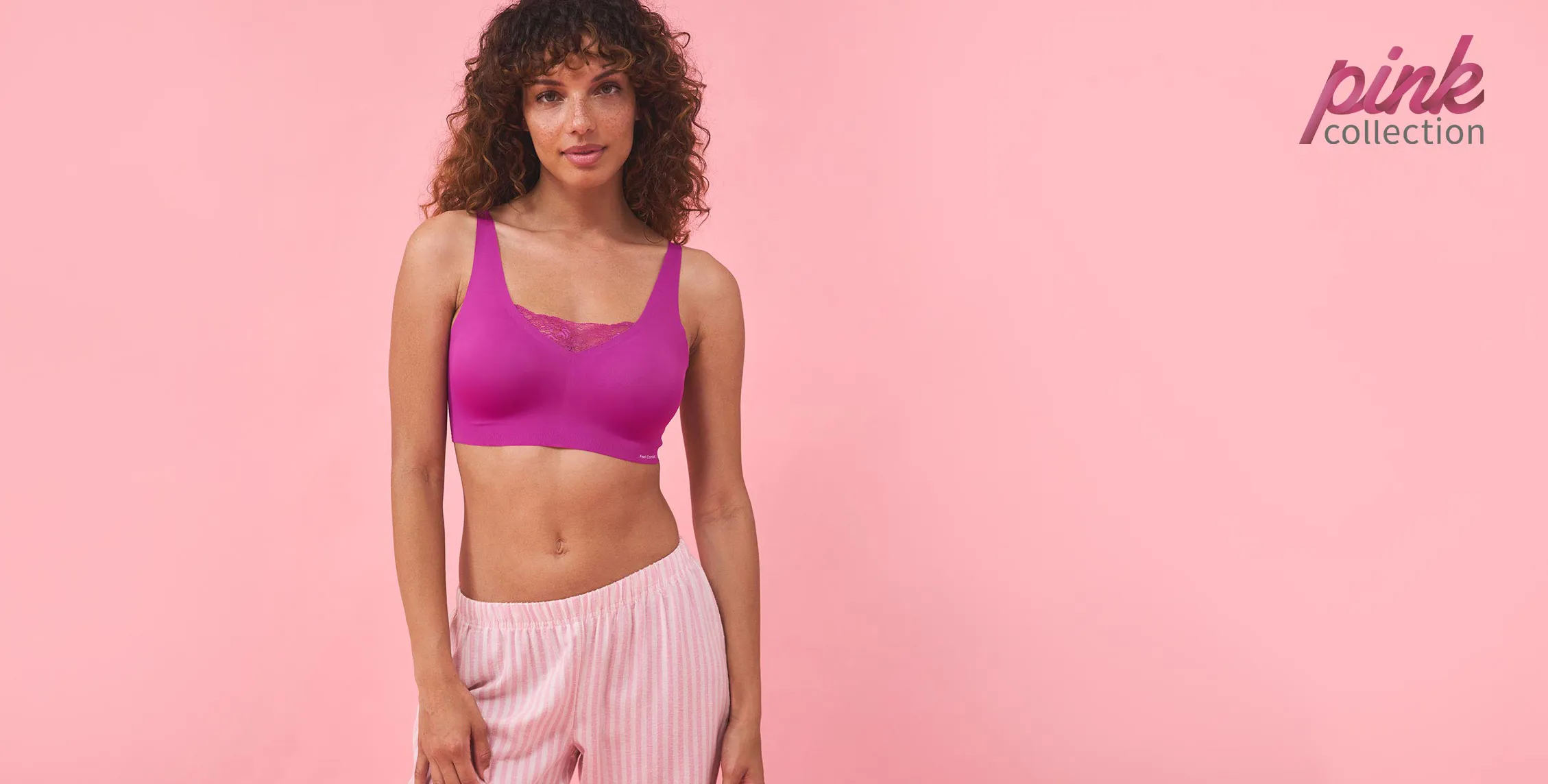 Tenue sportive : top crop lilas et pantalon rayé rose. Parfait pour le fitness ou les loisirs.